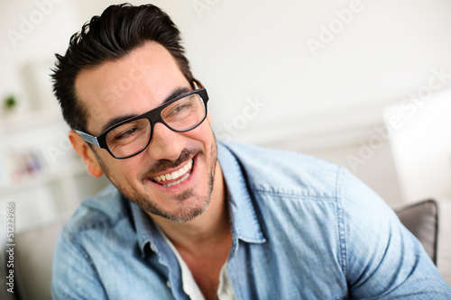 Photo: Cheerful trendy guy with black eyeglasses on Cheerful trendy guy with black eyeglasses on