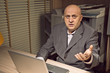 Photo: angry businessman working at night angry businessman working at night