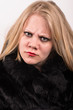 sour and stubborn young woman in a fur jacket