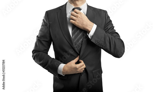 Photo: man adjusts tie man adjusts tie