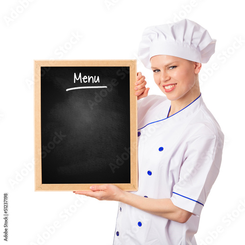 Photo: Pretty smiling chef woman holding menu blackboard Pretty smiling chef woman holding menu blackboard