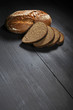 Sliced black bread on wooden table