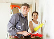woman and man makes repairs in home