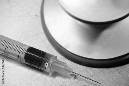 Photo: Syringe and stethoscope. Medical symbols. Syringe and stethoscope. Medical symbols.