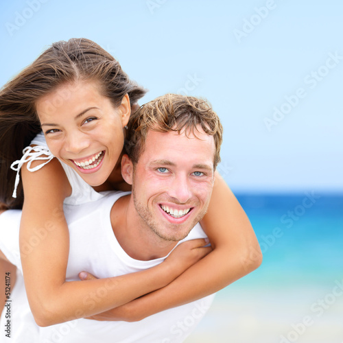 Photo: Happy couple on beach summer fun vacation Happy couple on beach summer fun vacation