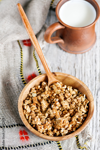 Photo: Muesli in wooden plate and milk Muesli in wooden plate and milk