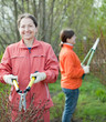 Female gardener cuts branches