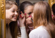 Beautiful teenage girlfriends having fun while putting make up