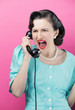 Woman yelling into an old-fashioned telephone