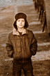 Retro black and white photo of sepia Boy homeless bum in brown j