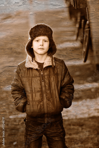 Photo: Retro black and white photo of sepia Boy homeless bum in brown j Retro black and white photo of sepia Boy homeless bum in brown j