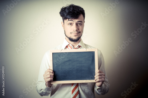 Photo: businessman with a blank blackboard businessman with a blank blackboard
