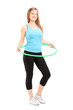 Full length potrait of a young female athlete exercising with a