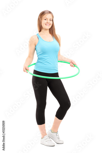 Photo: Full length potrait of a young female athlete exercising with a Full length potrait of a young female athlete exercising with a