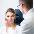 Photo: optometry concept - pretty young woman having her eyes examined optometry concept - pretty young woman having her eyes examined