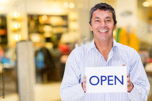 Photo: Business owner with an open sign Business owner with an open sign