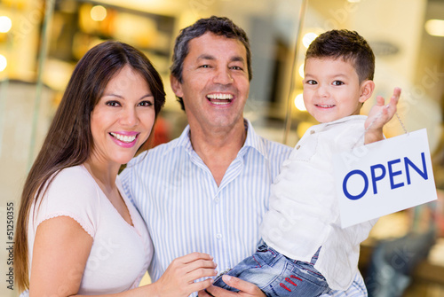 Photo: Family holding an open sign Family holding an open sign
