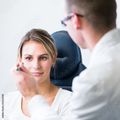 Photo: optometry concept - pretty young woman having her eyes examined optometry concept - pretty young woman having her eyes examined