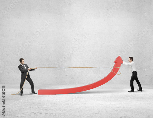 Photo: twoo businessman pulling a rope red arrow in room twoo businessman pulling a rope red arrow in room