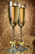 Photo: Two glasses of champagne on bright background with lights Two glasses of champagne on bright background with lights