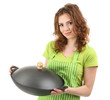 Young woman wearing kitchen apron with wok pan, isolated