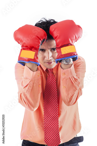 Photo: Businessman with boxing gloves - isolated Businessman with boxing gloves - isolated