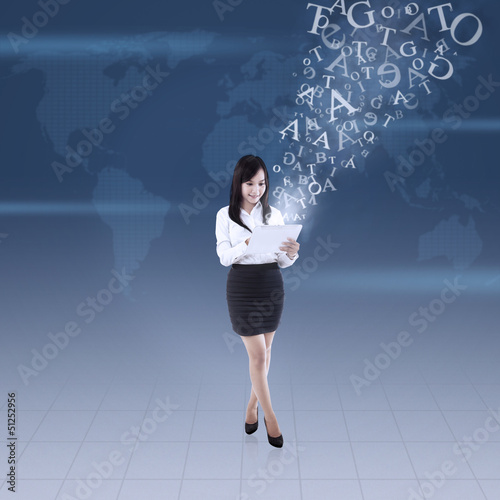 Photo: Businesswoman send email globally Businesswoman send email globally
