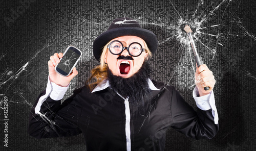 Photo: Business man with cracked mobile phone screen Business man with cracked mobile phone screen