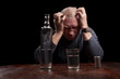 Dark portrait of a man holding his head in despair