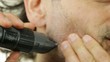 man with electric shaver