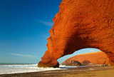 Red archs on atlantic ocean coast. Marocco