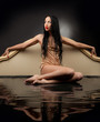Girl with  wet clothes sitting in the black water 
