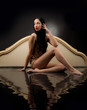 Girl with wet clothes sitting in the black water 