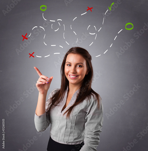 Photo: Young woman thinking with abstract marks overhead Young woman thinking with abstract marks overhead