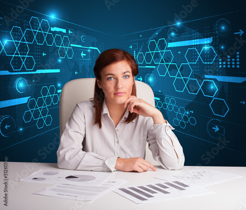 Photo: Businesswoman doing paperwork with futuristic background Businesswoman doing paperwork with futuristic background