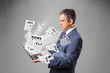 Photo: Middle aged businessman holding notebook and reading the explosi Middle aged businessman holding notebook and reading the explosi