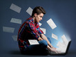 Young man receiving tons of messages on laptop