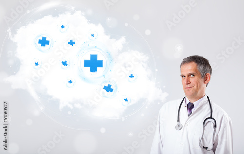 Photo: Doctor listening to abstract cloud with medical signs Doctor listening to abstract cloud with medical signs