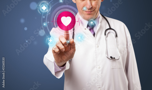 Photo: Middle aged doctor pressing modern medical type of button Middle aged doctor pressing modern medical type of button