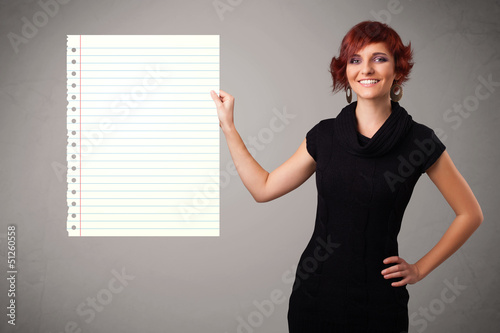 Photo: Young woman holding white paper copy space with diagonal lines Young woman holding white paper copy space with diagonal lines