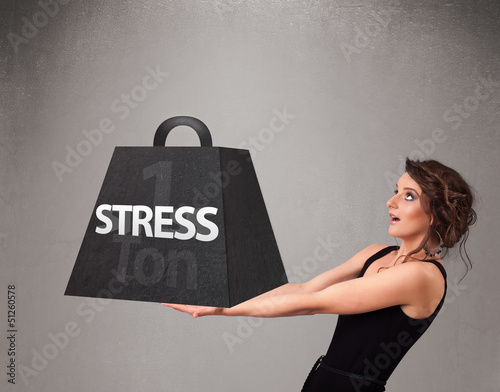 Photo: Young woman holding one ton of stress weight Young woman holding one ton of stress weight