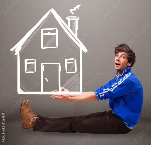 Photo: Young boy holding a huge drawn house Young boy holding a huge drawn house