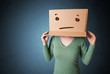 Young girl gesturing with a cardboard box on her head with strai