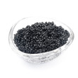 black caviar in a glass bowl isolated closeup