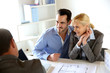 Couple meeting real-estate agent to buy property