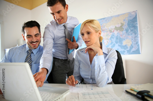 Photo: Business people meeting in office with laptop Business people meeting in office with laptop