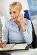 Businesswoman on the phone taking note on agenda