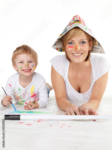 Photo: Cute boy and his mother painting with water colours Cute boy and his mother painting with water colours