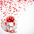 Geschenk mit Herzschleife und Konfetti