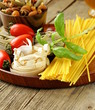 Various types of pasta (spaghetti, fettuccini, penne) and tomato